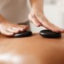 masseur-doing-back-hot-stone-massage-closeup-4NALQE2.jpg